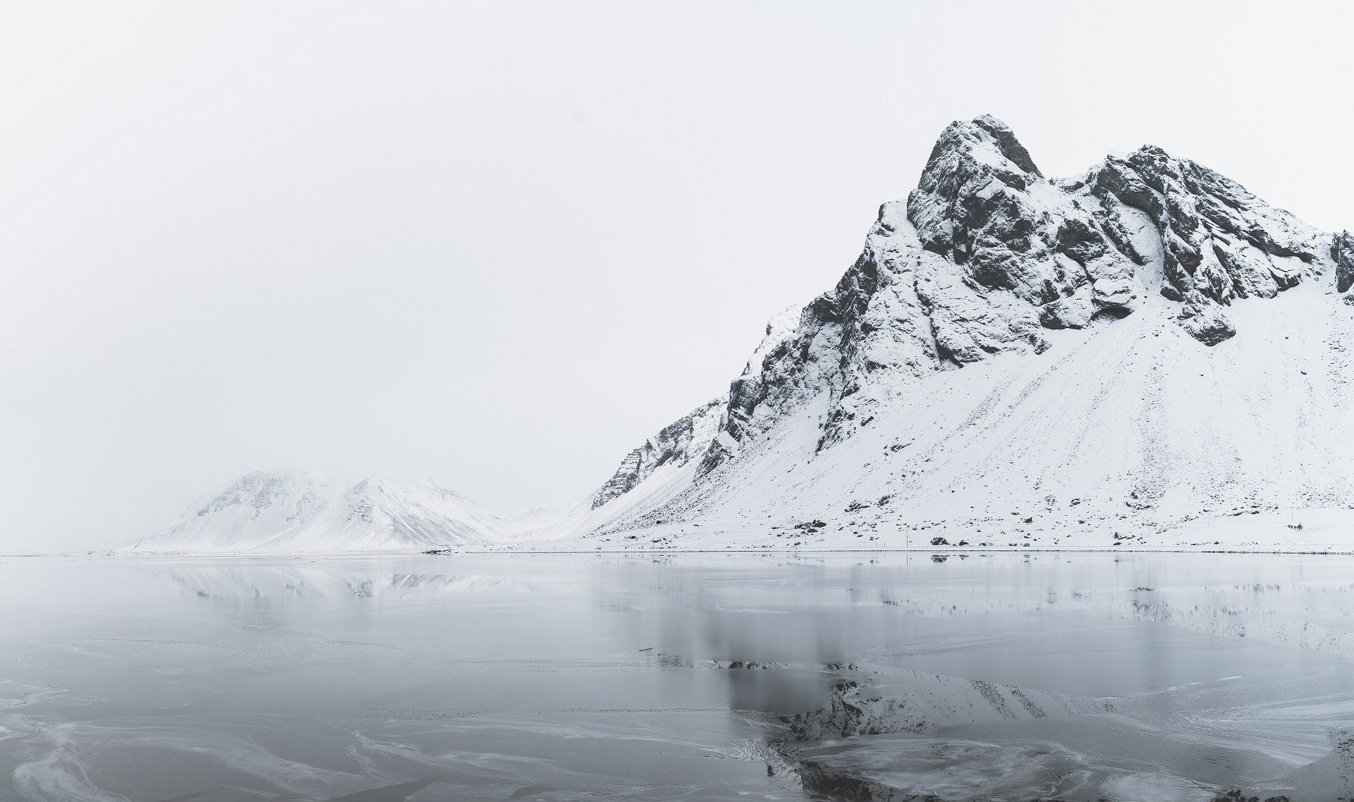 Stijl uit zee oprijzende bergen in de winter in IJsland