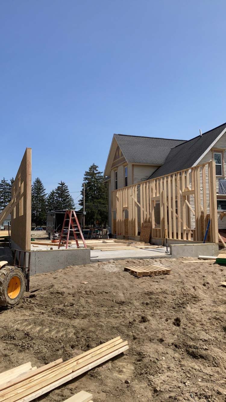 Construction site with wood framing; a building is under construction, sunny day.
