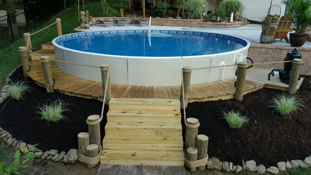 A swimming pool with a wooden bridge leading to it