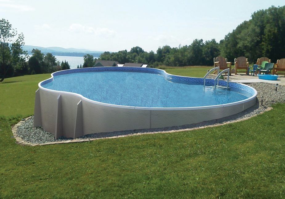 A large swimming pool in a backyard with a view of a lake