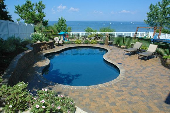 A large swimming pool with a view of the ocean