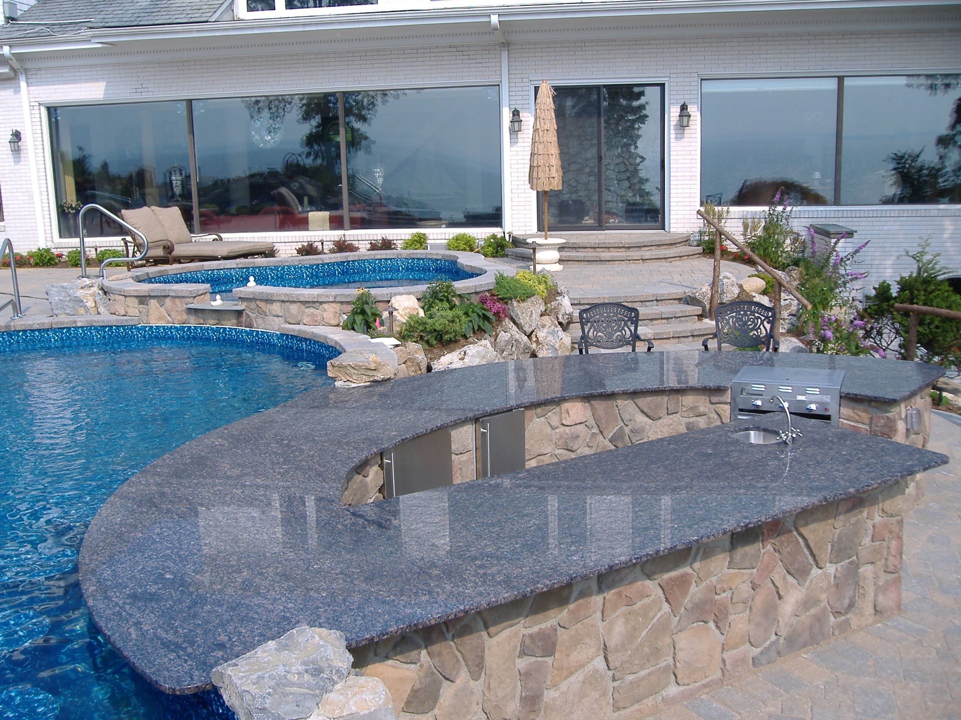 A large swimming pool with a bar in front of it