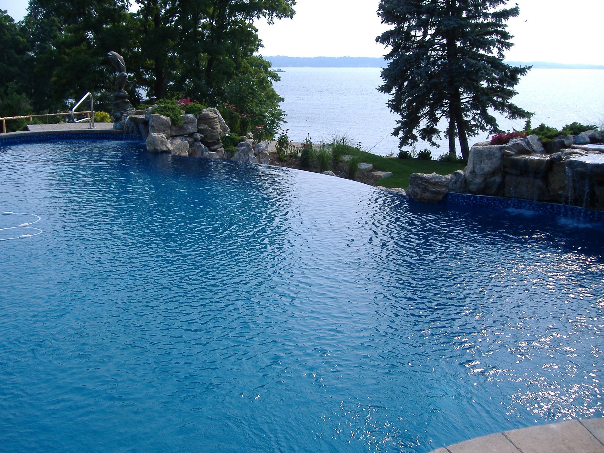 A large swimming pool with a view of the ocean