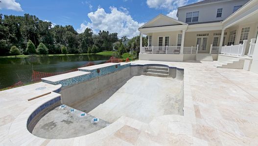 A large house with a large swimming pool in front of it