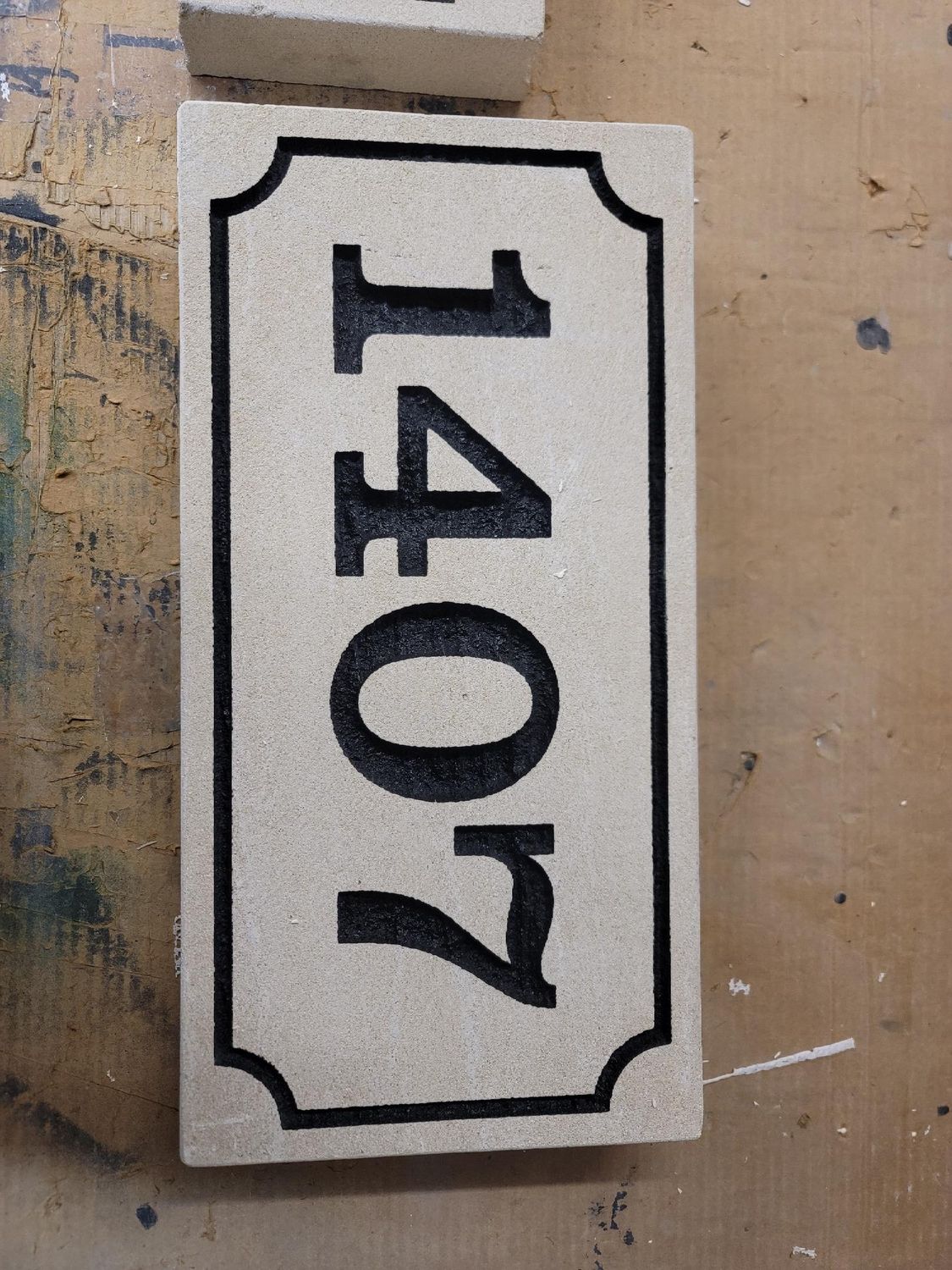 Address sign with black numbers 