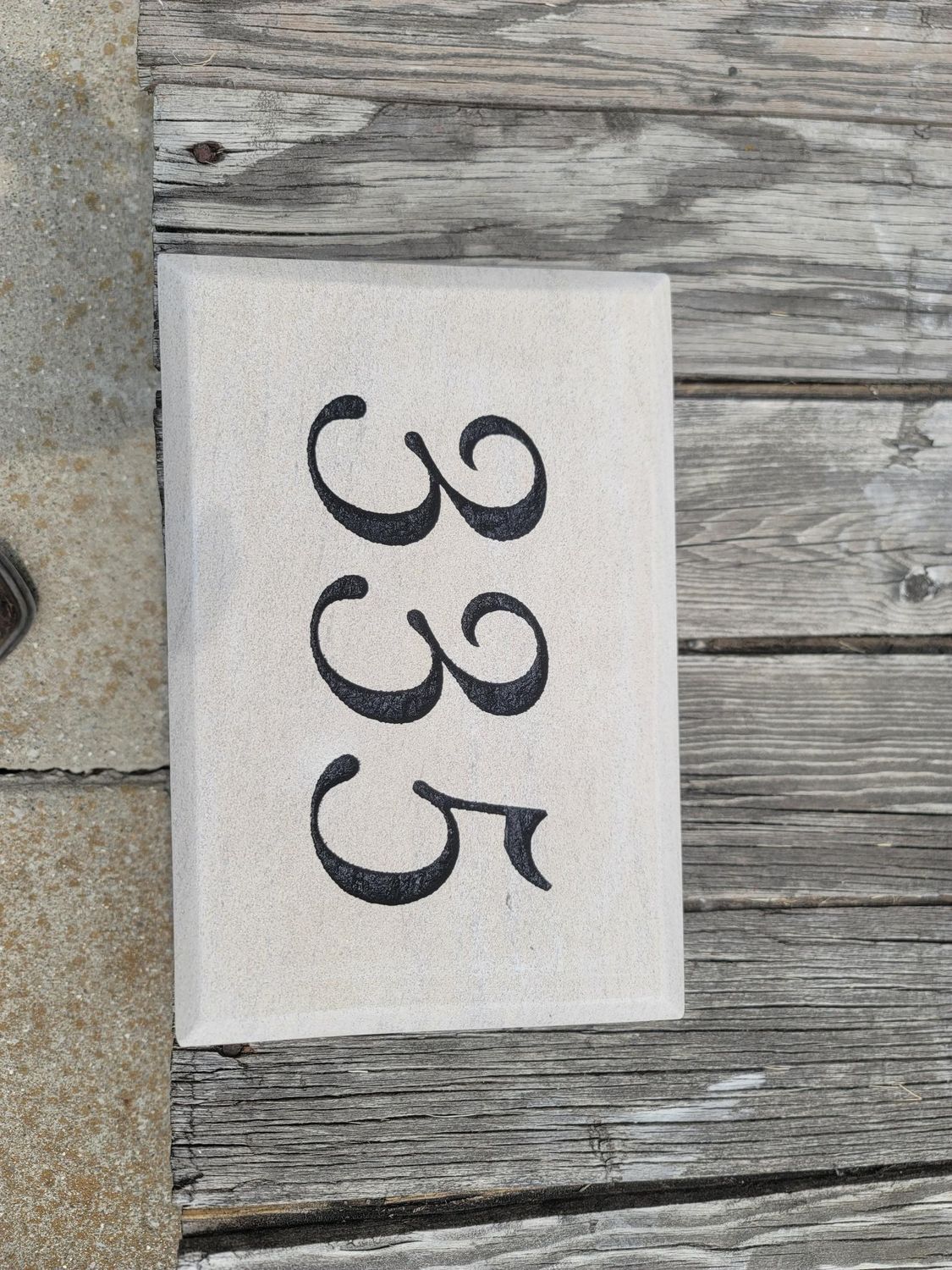 Stone plaque with black numbers 
