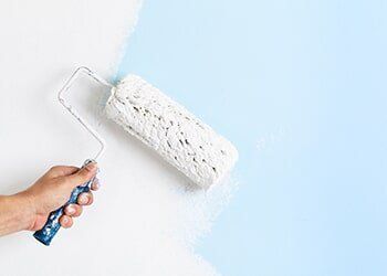 House Painting Services — Close Up of Painter Hand Painting a Wall in Damascus, OR