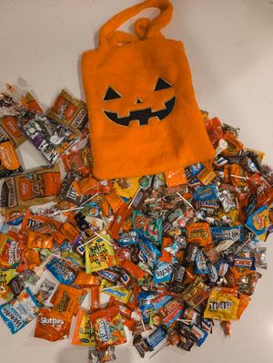 A person holding a baby up in the air indoors near a window, baby smiling.