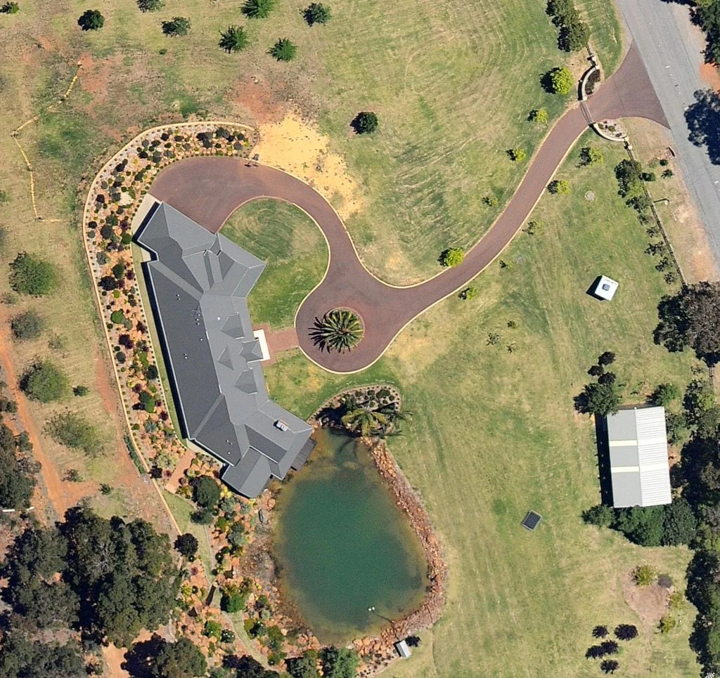 A House With A Driveway And Pond — Territory Bitumen Services In Tivendale, NT
