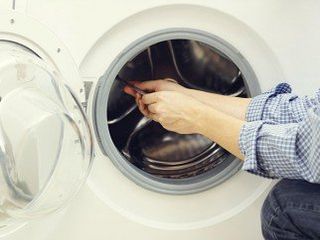 Man Repairing Washing Machine - Major Appliances in Utica, NY