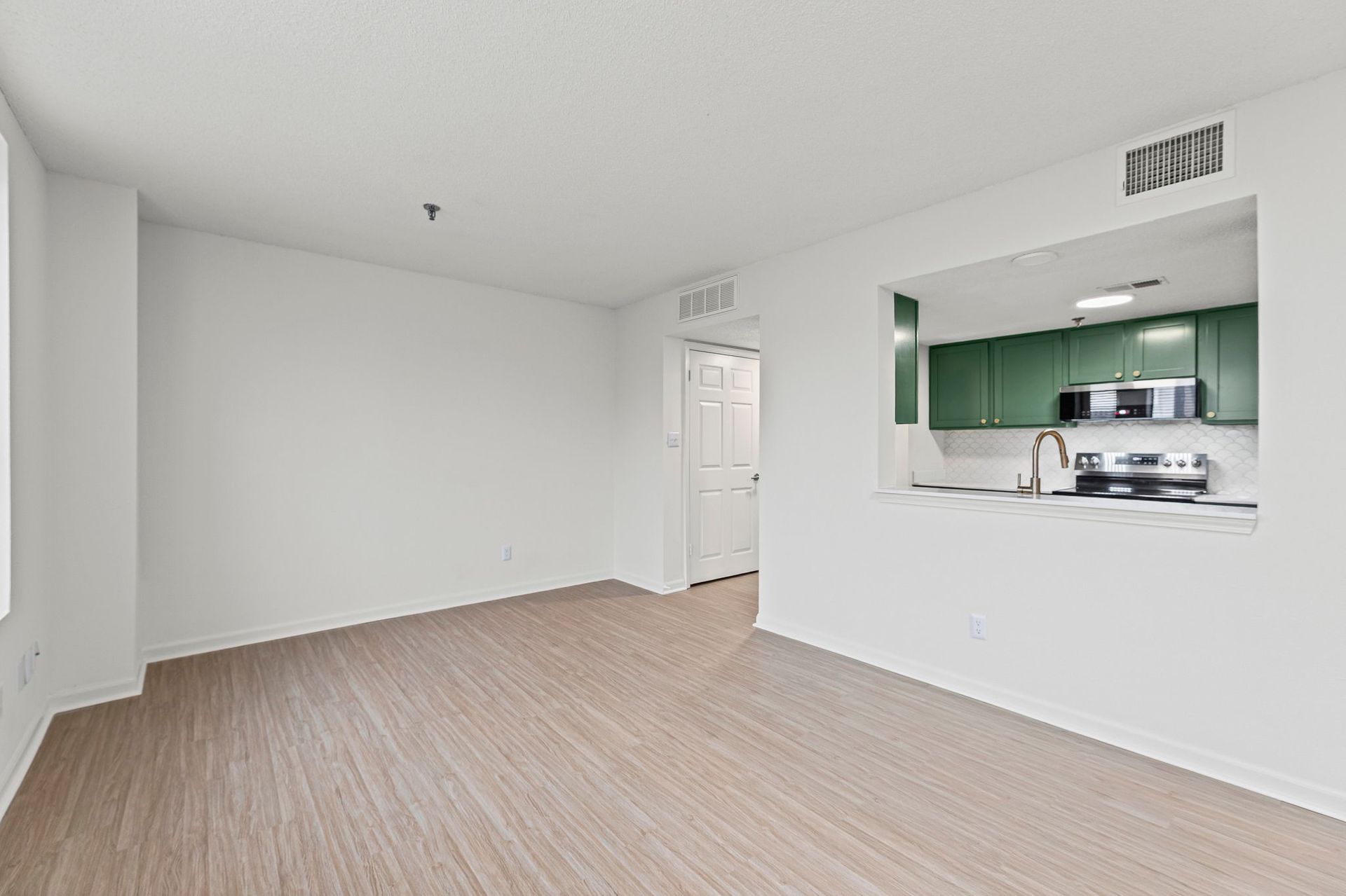Renovated apartment featuring new flooring and paint