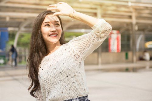 Woman Covering Her Face From Sunlight