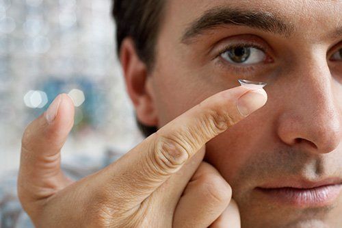 a man holding a eye contact a man holding a eye contact