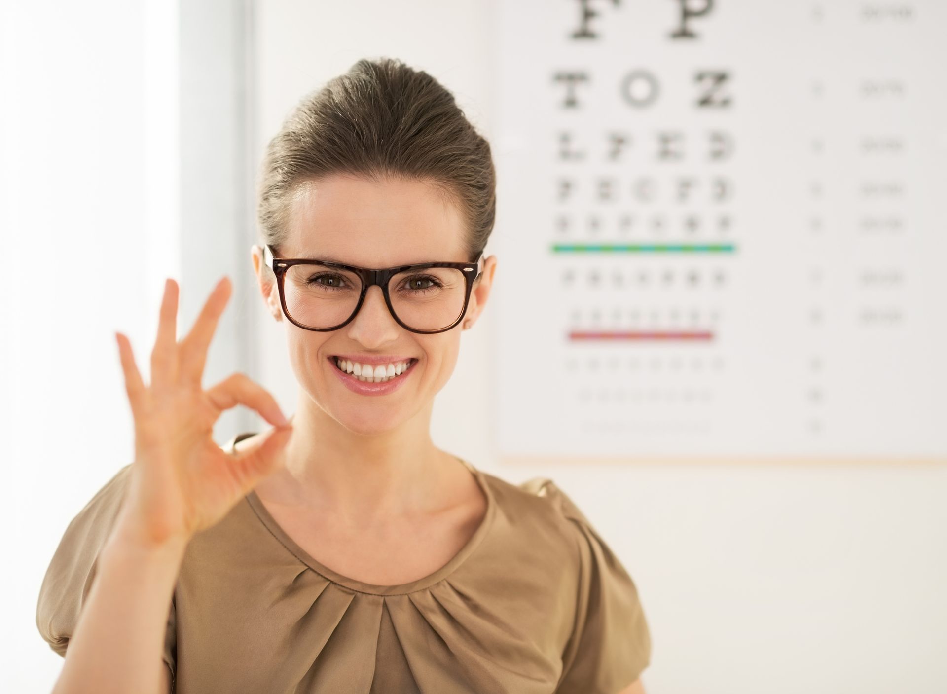 Patient after an eye exam at Calvert Ophthalmology Center in Nashville, TN, smiling with glasses