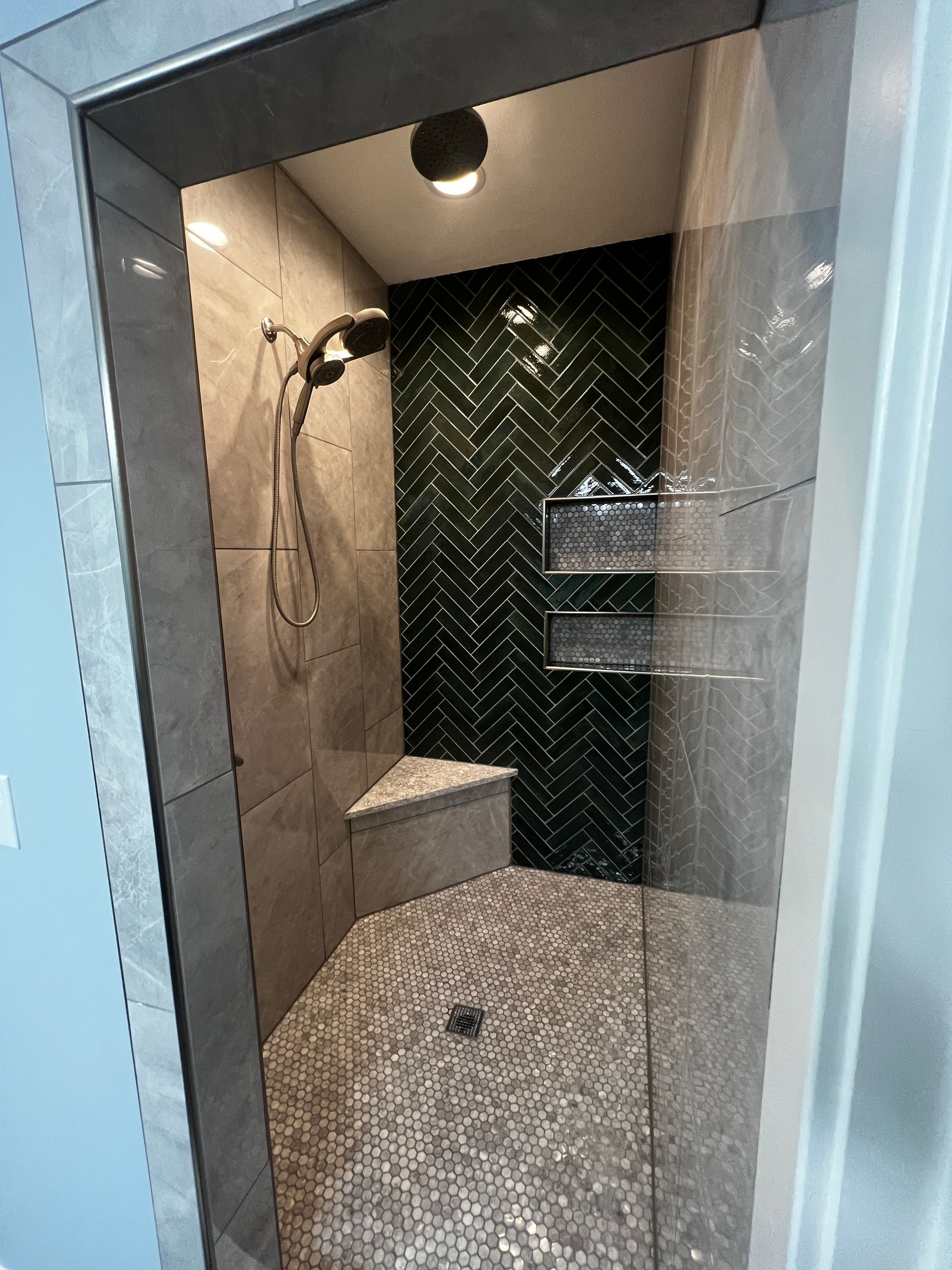 A bathroom with a shower and a bench in it