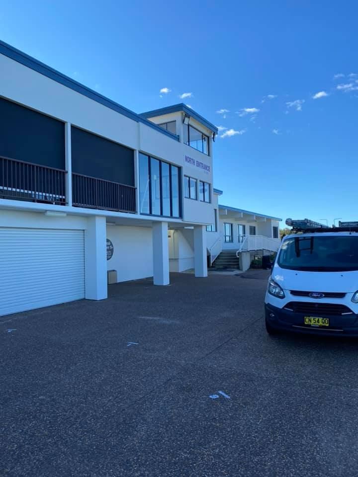 Two-Story White Building With Black Awnings — S D Maintenance In Point Clare, NSW