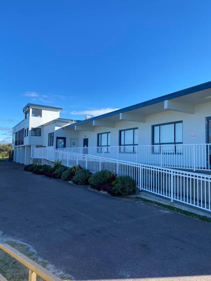 White building with blue trim and windows, a ramp, and a bright blue sky. — S D Maintenance In Point Clare, NSW
