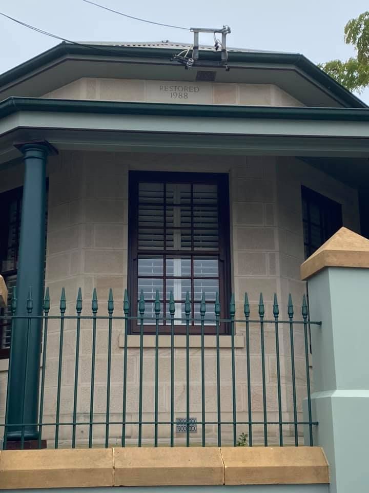 Beige Stone House With Green Trim and Dark Window — S D Maintenance In Point Clare, NSW