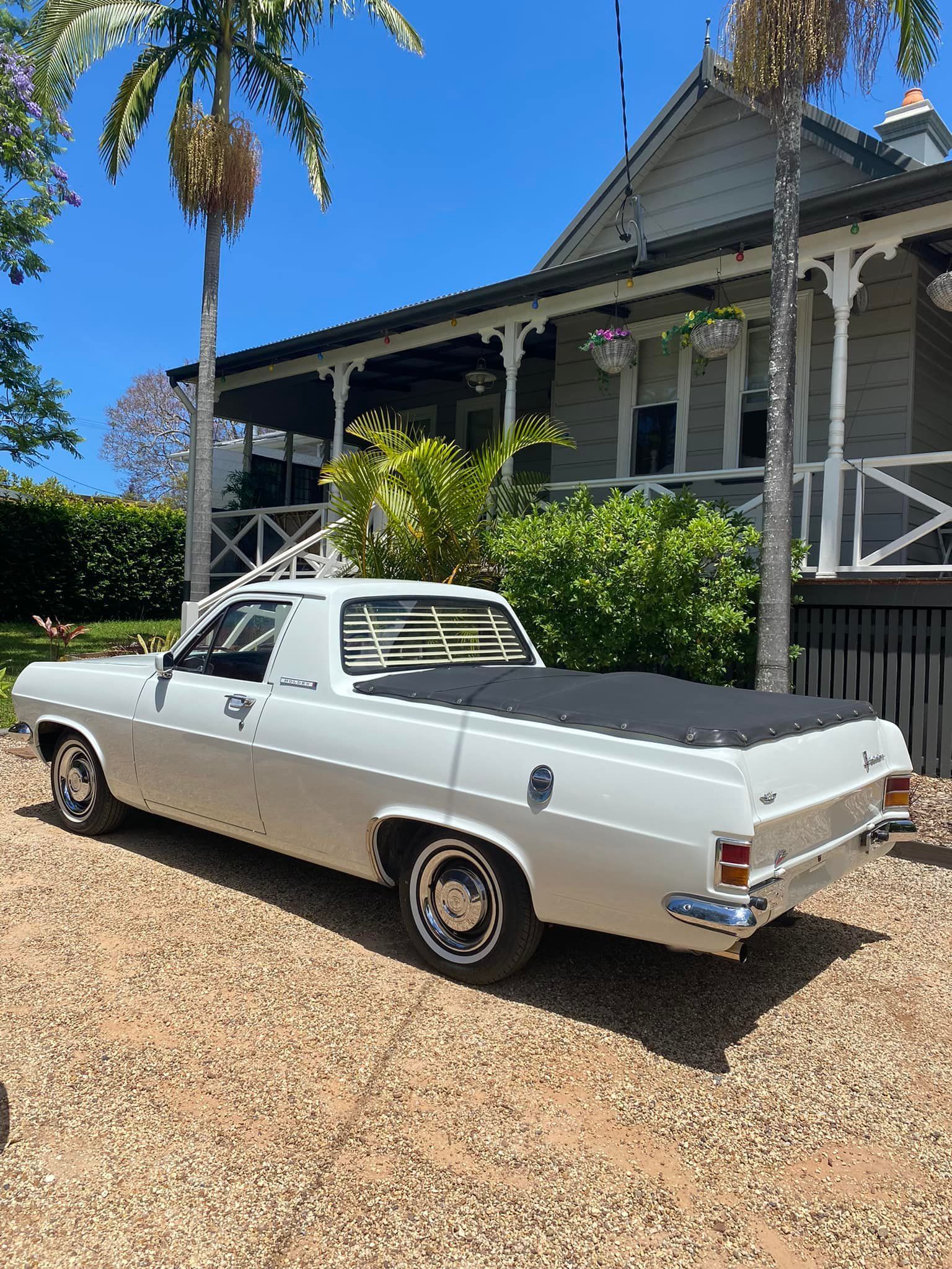 White utility vehicle parked on gravel in front of a house on a sunny day. — S D Maintenance In Point Clare, NSW