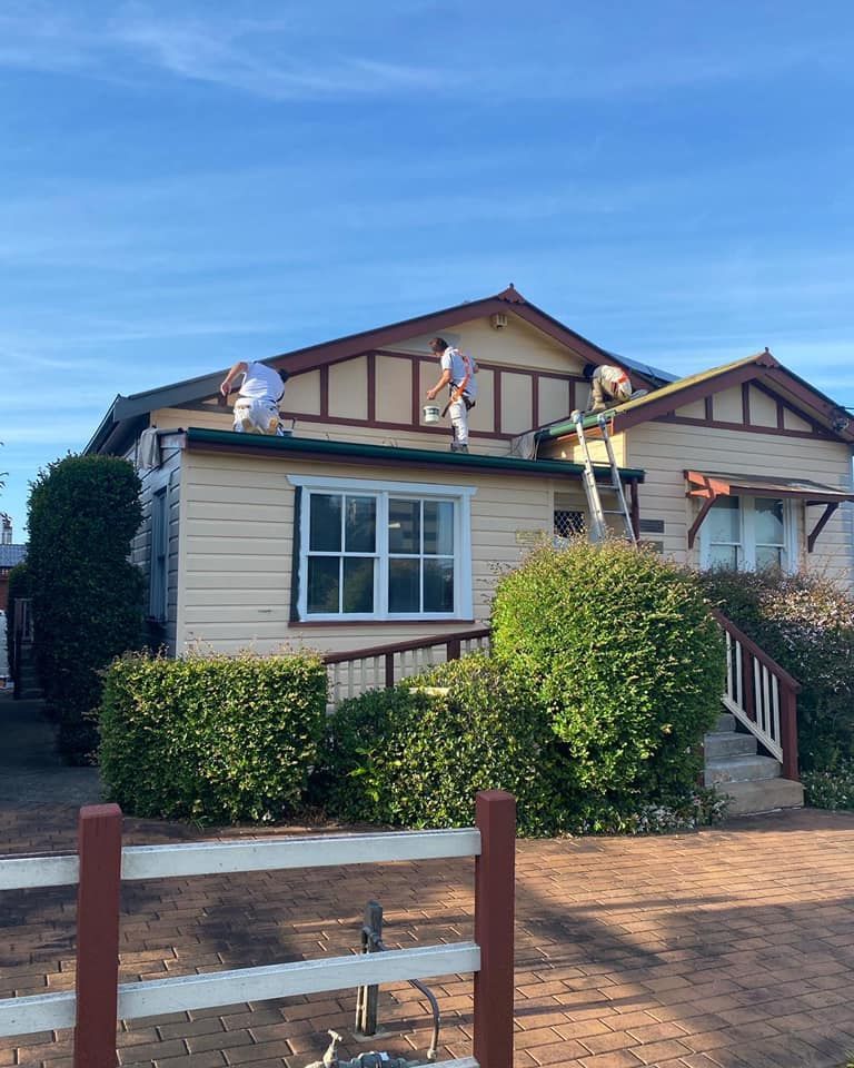 Men Painting the Roof of a Beige House With Brown Trim — S D Maintenance In Point Clare, NSW