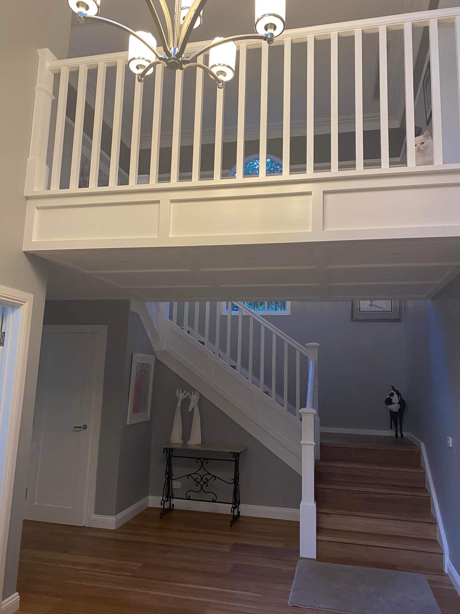 Interior View of a Home Entryway With a Loft, Staircase and White Railing — S D Maintenance In Point Clare, NSW