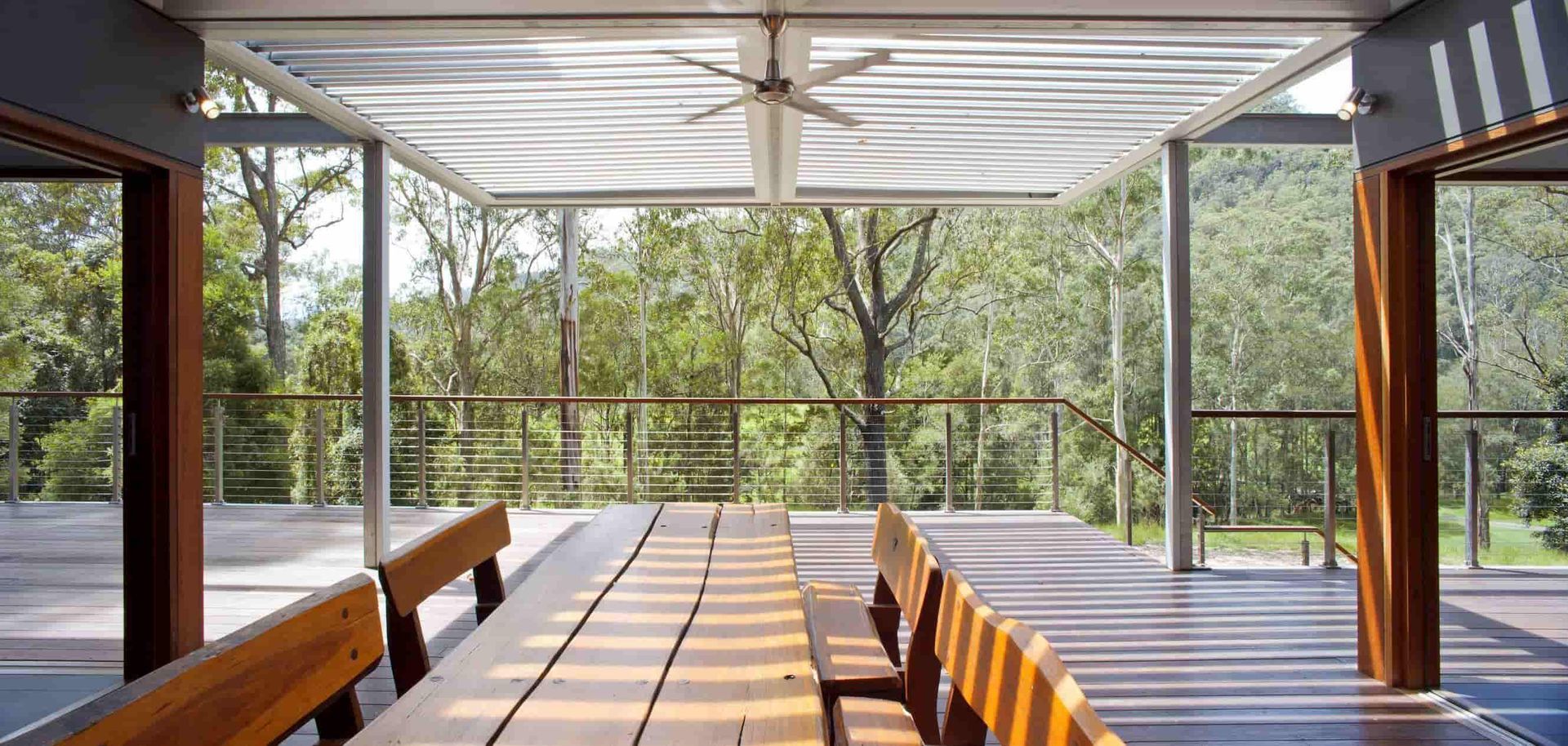 Wooden Outdoor Dining Area With a View of Lush Green Trees — S D Maintenance In The Entrance, NSW