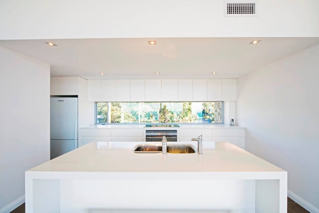 Modern White Kitchen With Long Window — S D Maintenance In Point Clare, NSW
