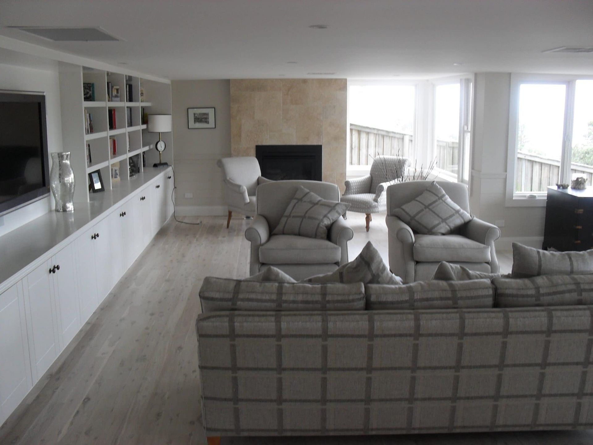 Living Room With Fireplace, Built-in Shelves, and Plaid Patterned Furniture — S D Maintenance In Terrigal, NSW