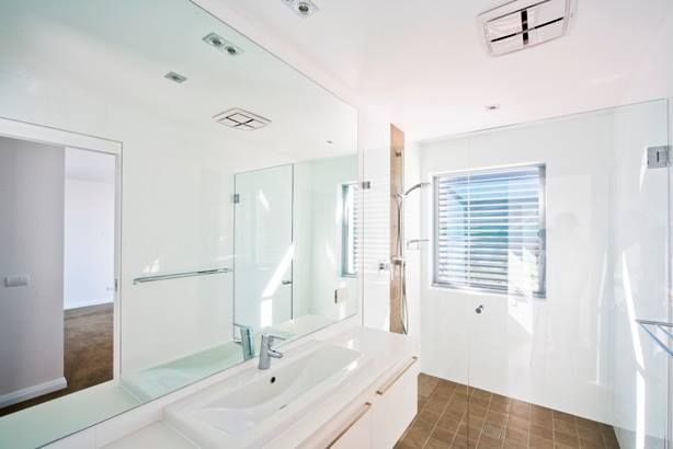Bright White Bathroom With a Large Mirror, Sink, Shower, and Window — S D Maintenance In Gosford, NSW