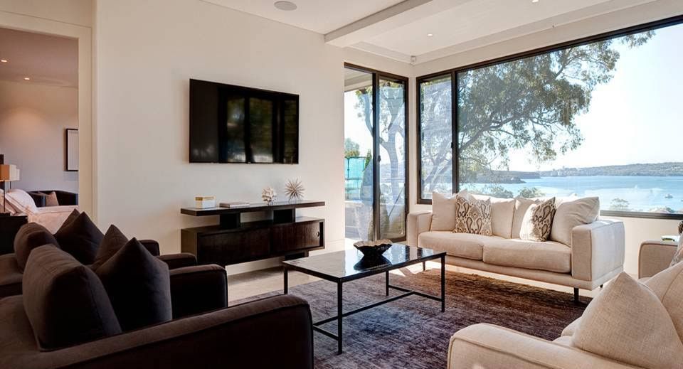 Living Room With Dark Gray Sofas, Beige Couch, Large Window — S D Maintenance In Point Clare, NSW