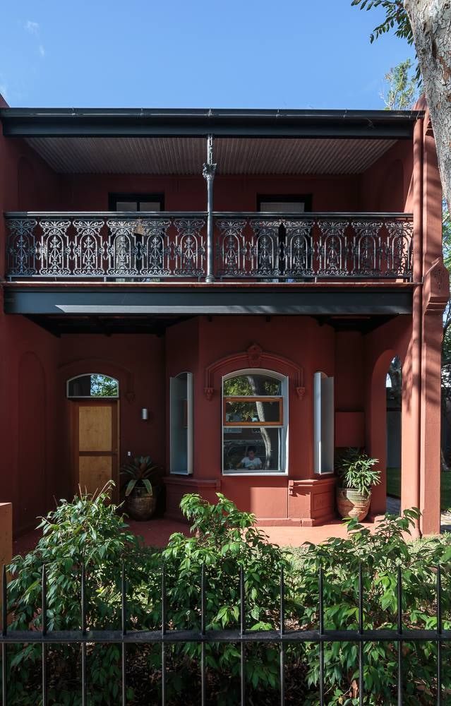 Red Brick Building With Black Wrought Iron Balcony — S D Maintenance In Point Clare, NSW
