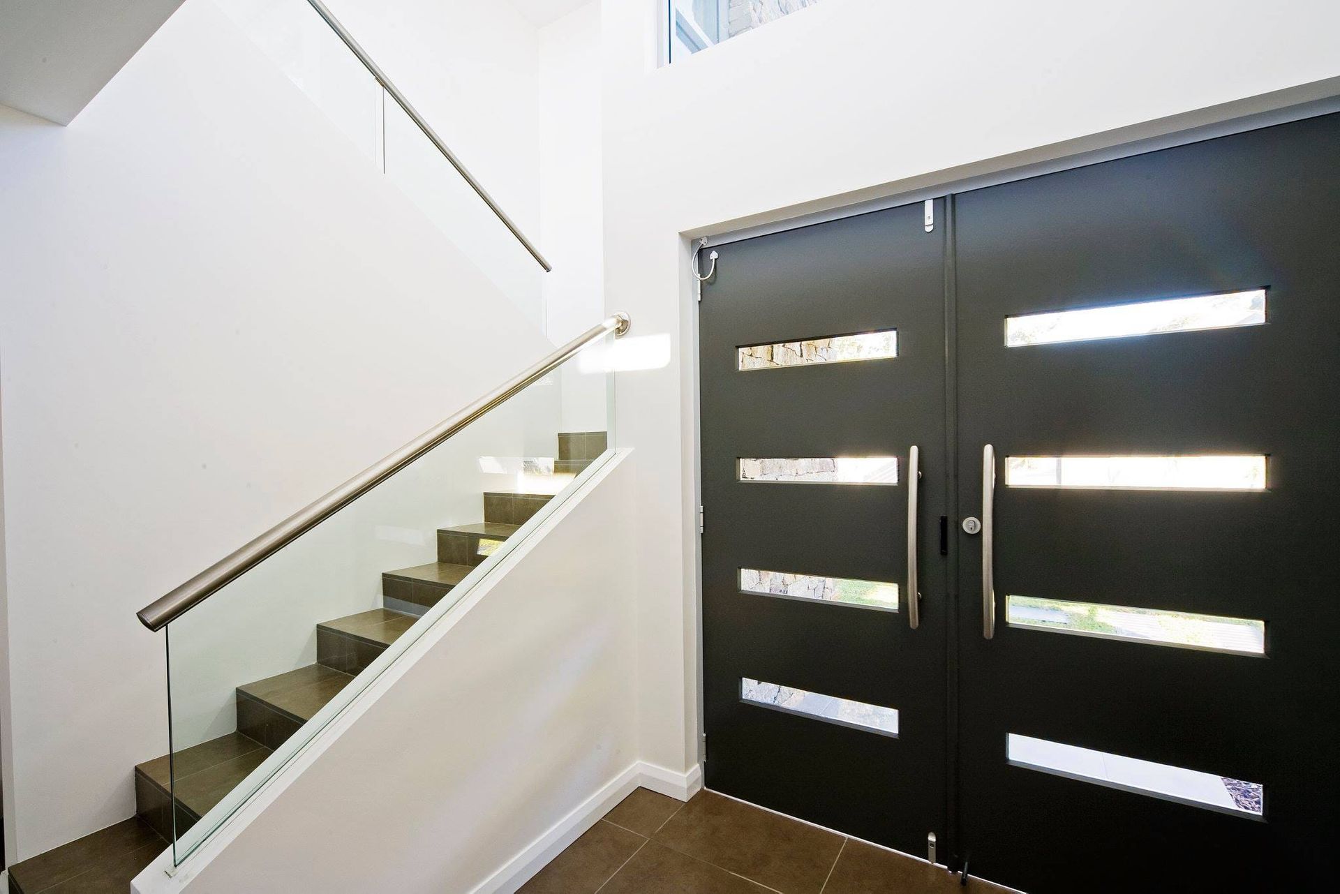 Modern Entry With Dark Double Doors, Glass Railing Stairs, and a White Wall — S D Maintenance In Gosford, NSW