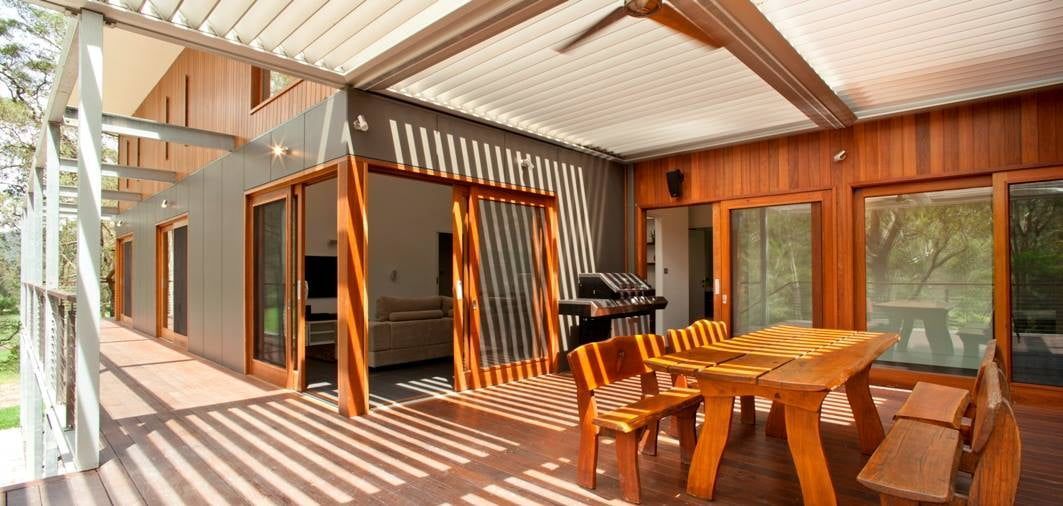 Wooden Patio With a Table, Chairs, and Sliding Doors — S D Maintenance In Point Clare, NSW