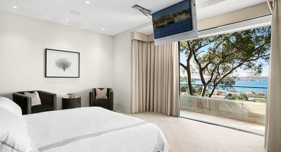 Bedroom With a Bed, Chairs, and a Ceiling-mounted Tv — S D Maintenance In Point Clare, NSW