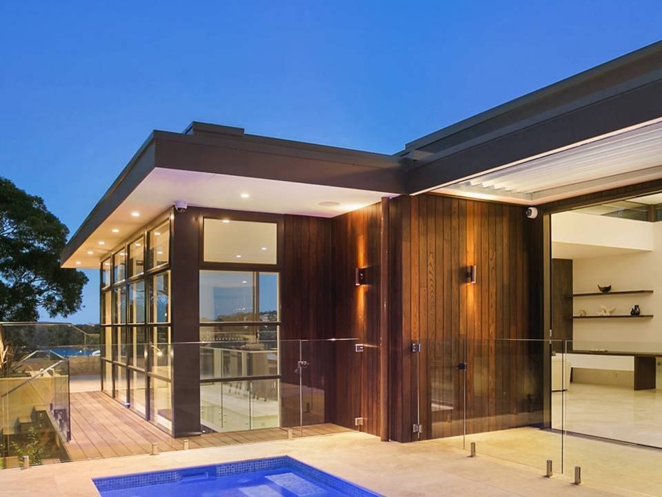 Exterior of Modern Home With Wood Siding, Glass Walls, Pool, and Dusk Sky — S D Maintenance In Terrigal, NSW