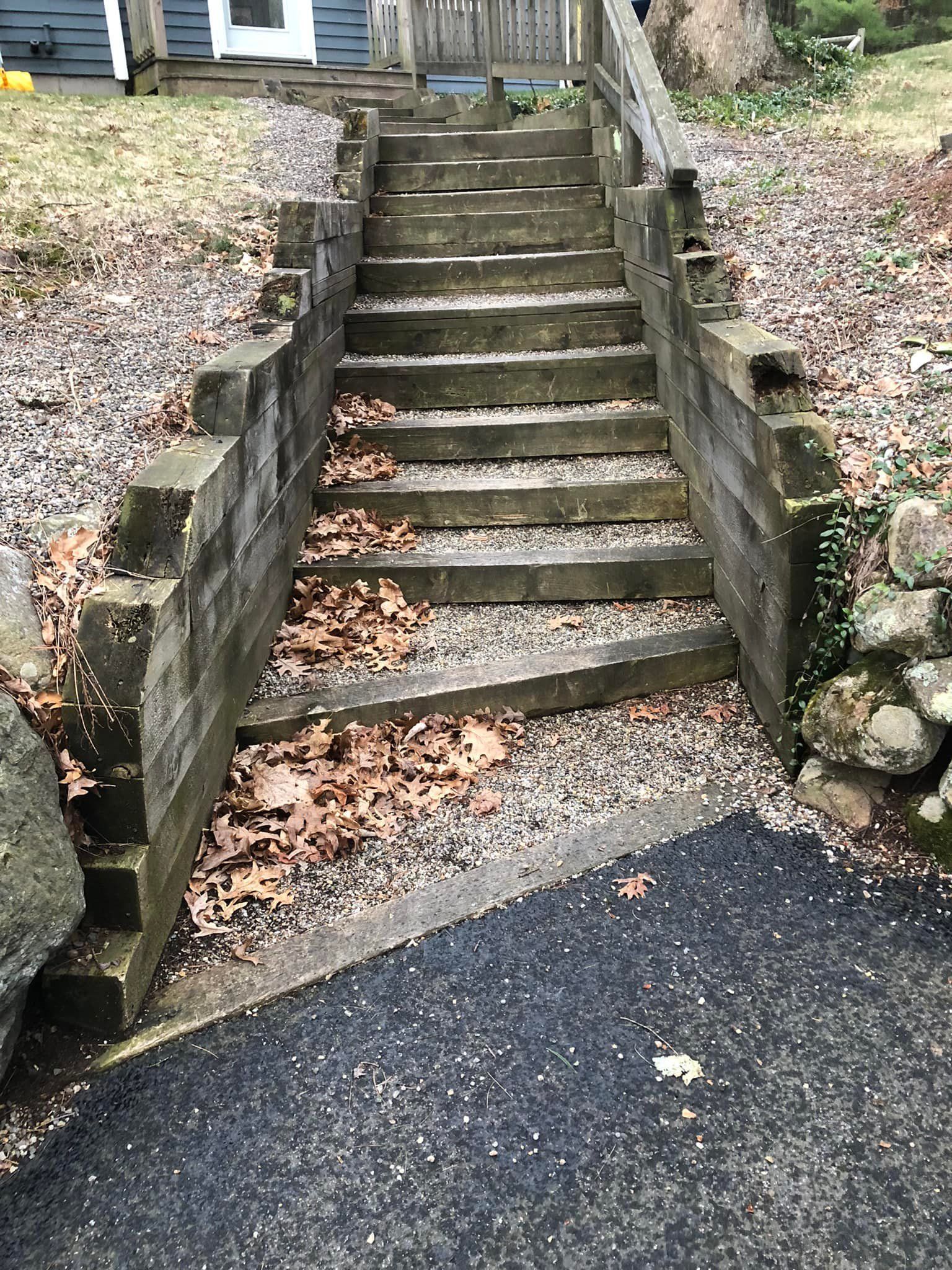 A set of wooden stairs leading up to a house.