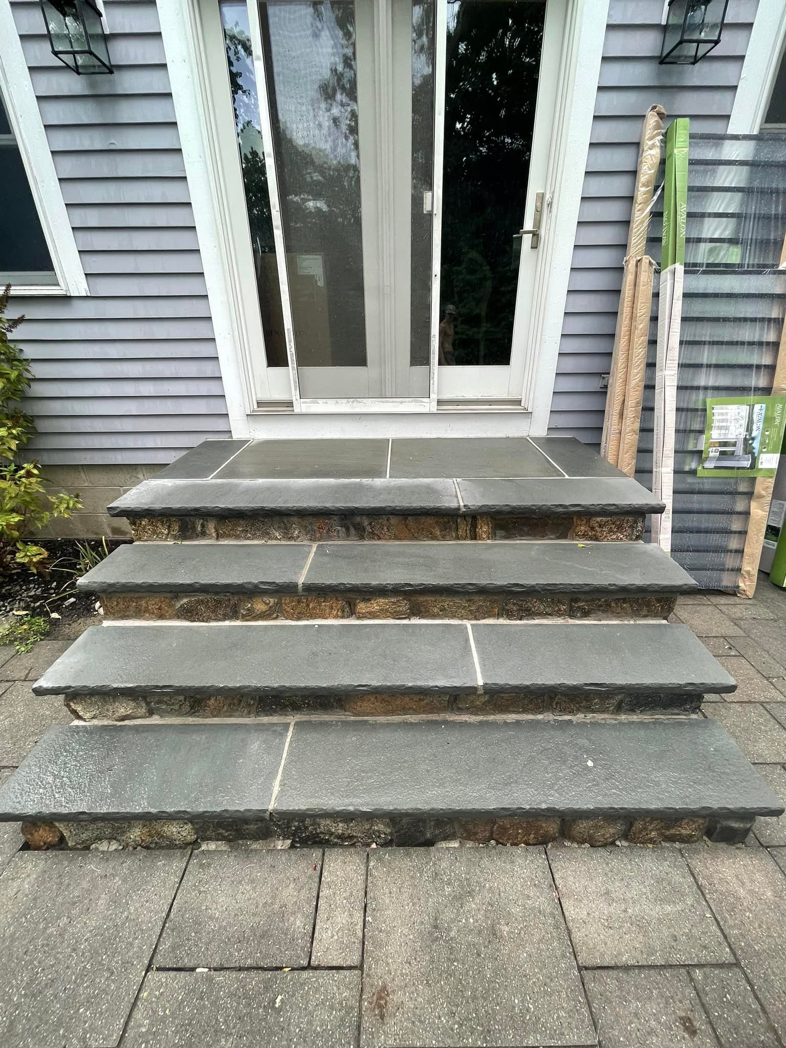 A set of stairs leading up to the front door of a house.