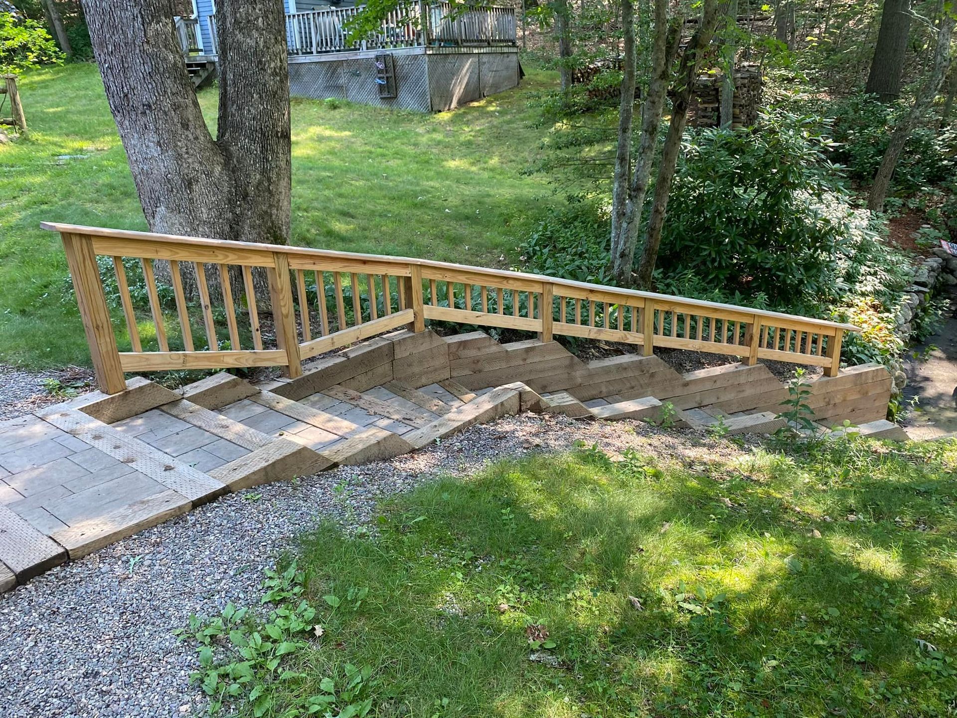 A wooden ramp is being built in the backyard of a house.