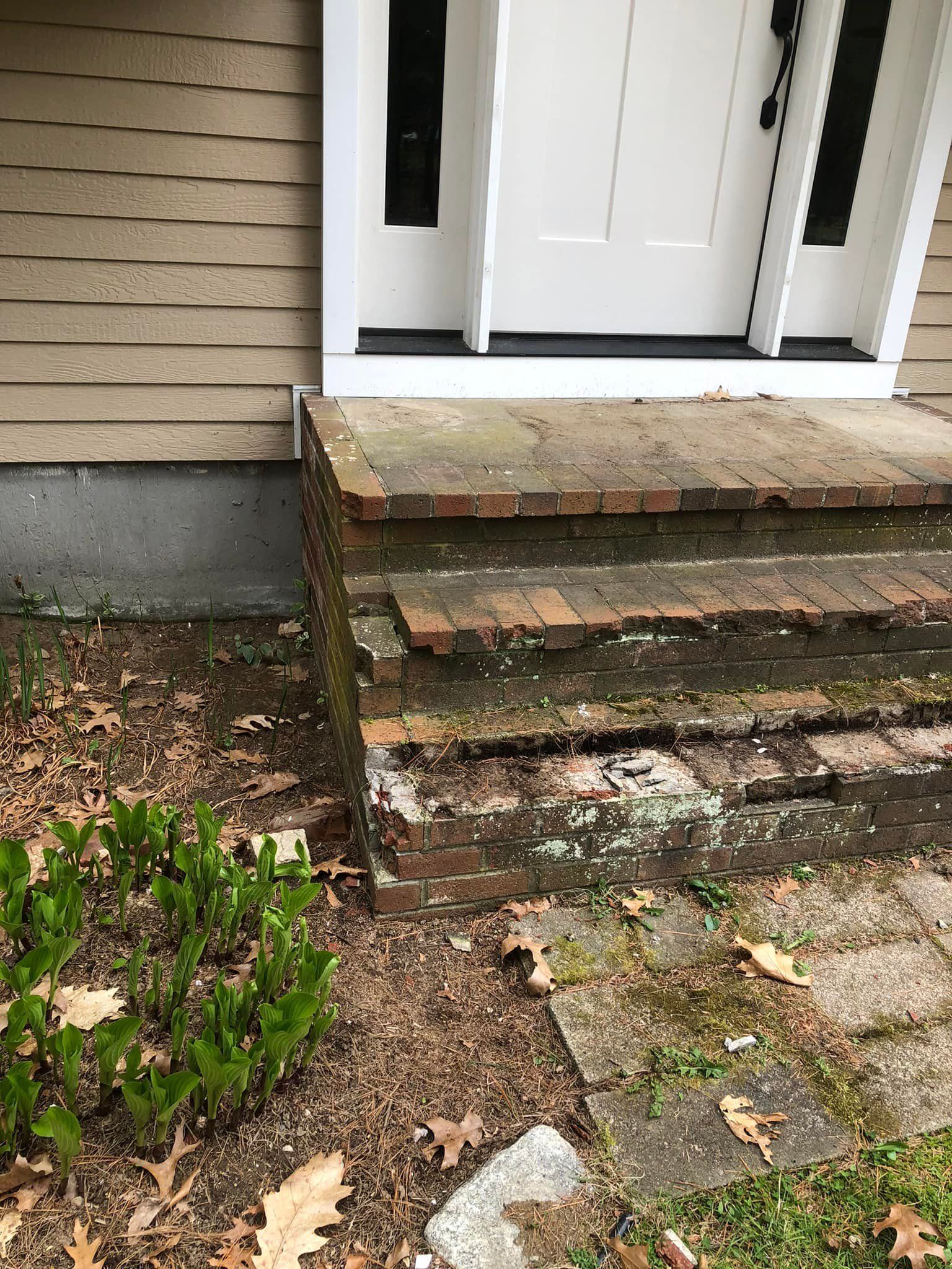 A set of stairs leading up to the front door of a house.