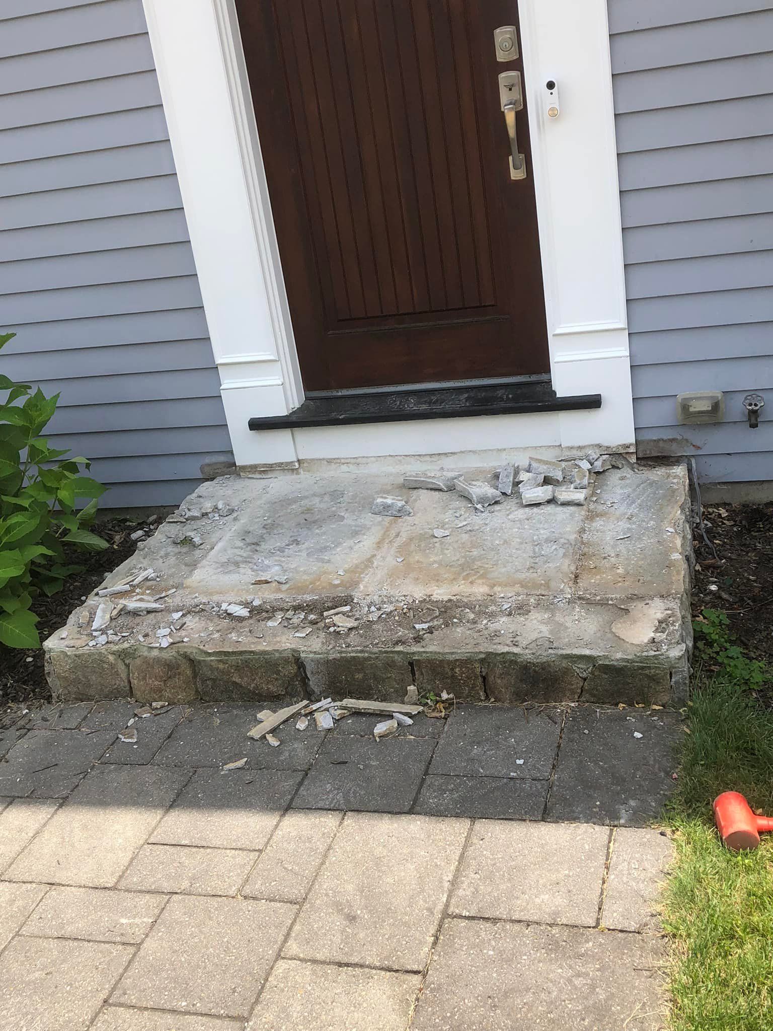 The front steps of a house are being remodeled.