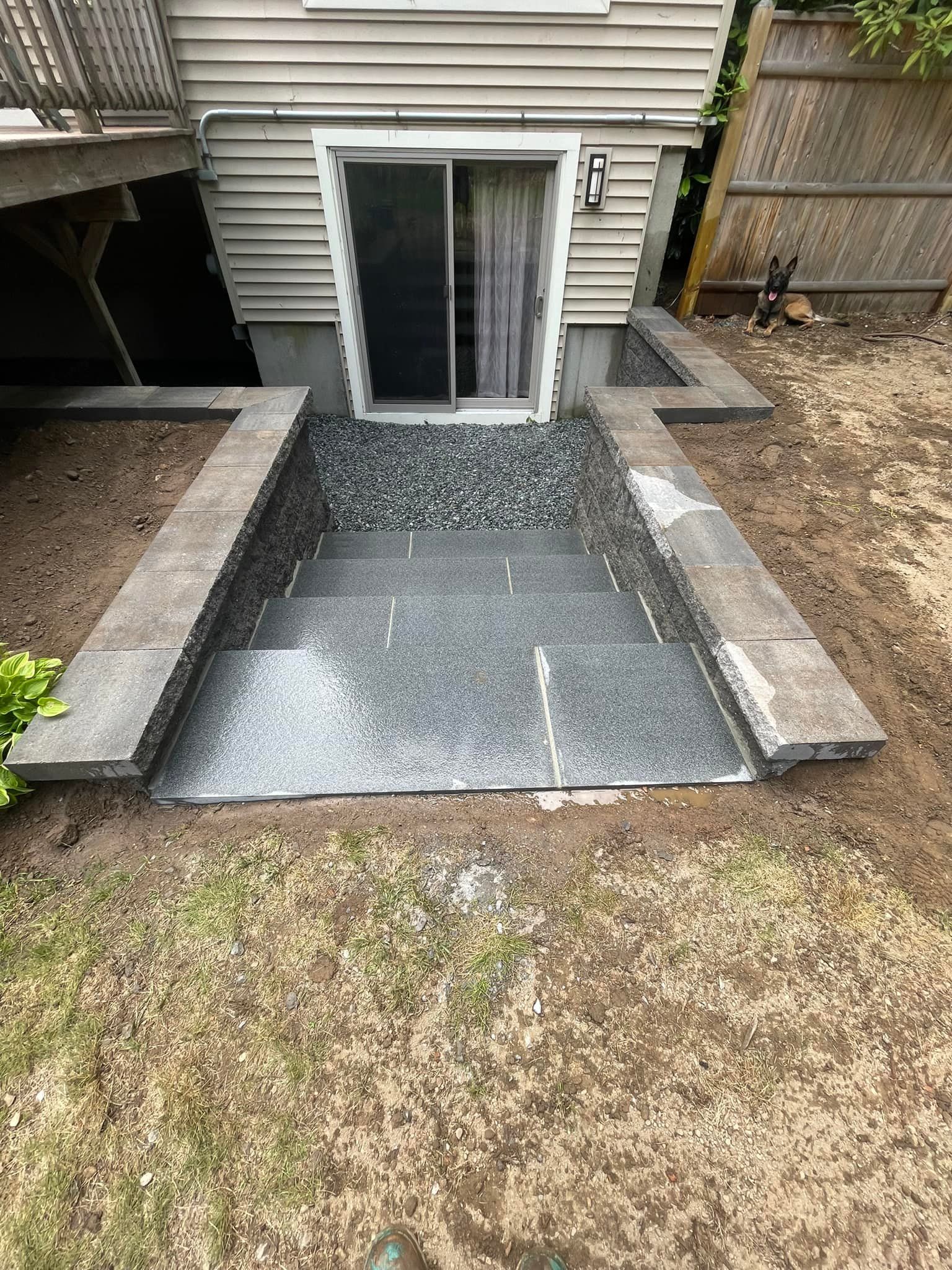 A swimming pool is being built in the backyard of a house.