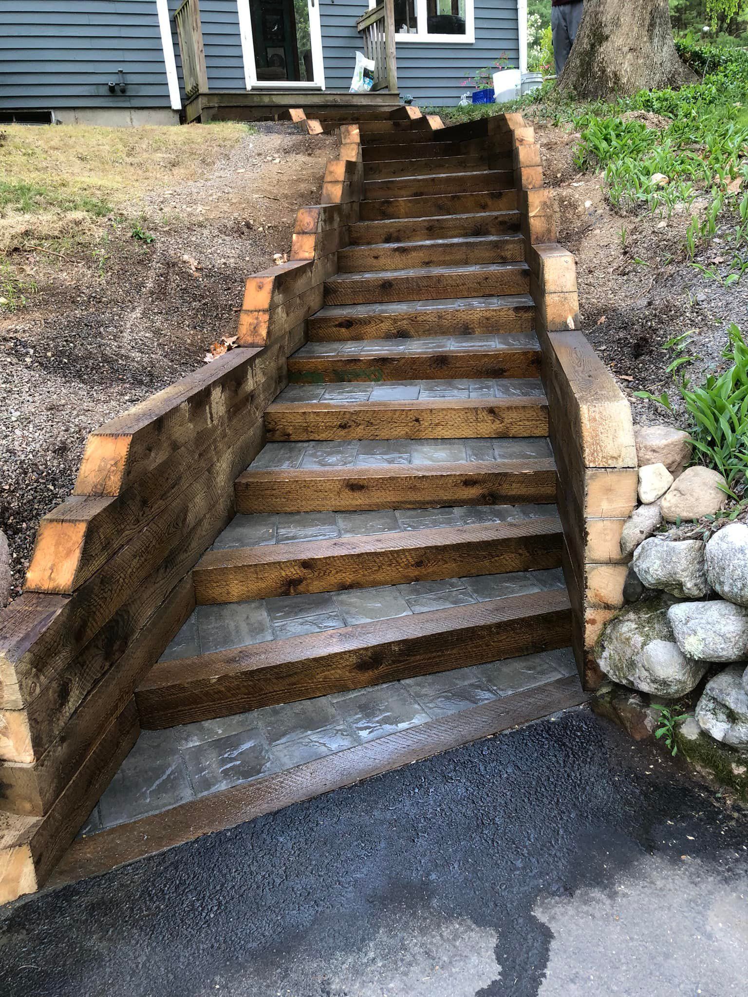 A set of wooden stairs leading up to a house.
