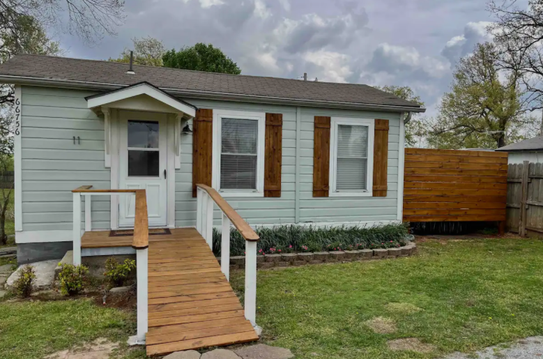 A small house with a wooden ramp leading to the front door.