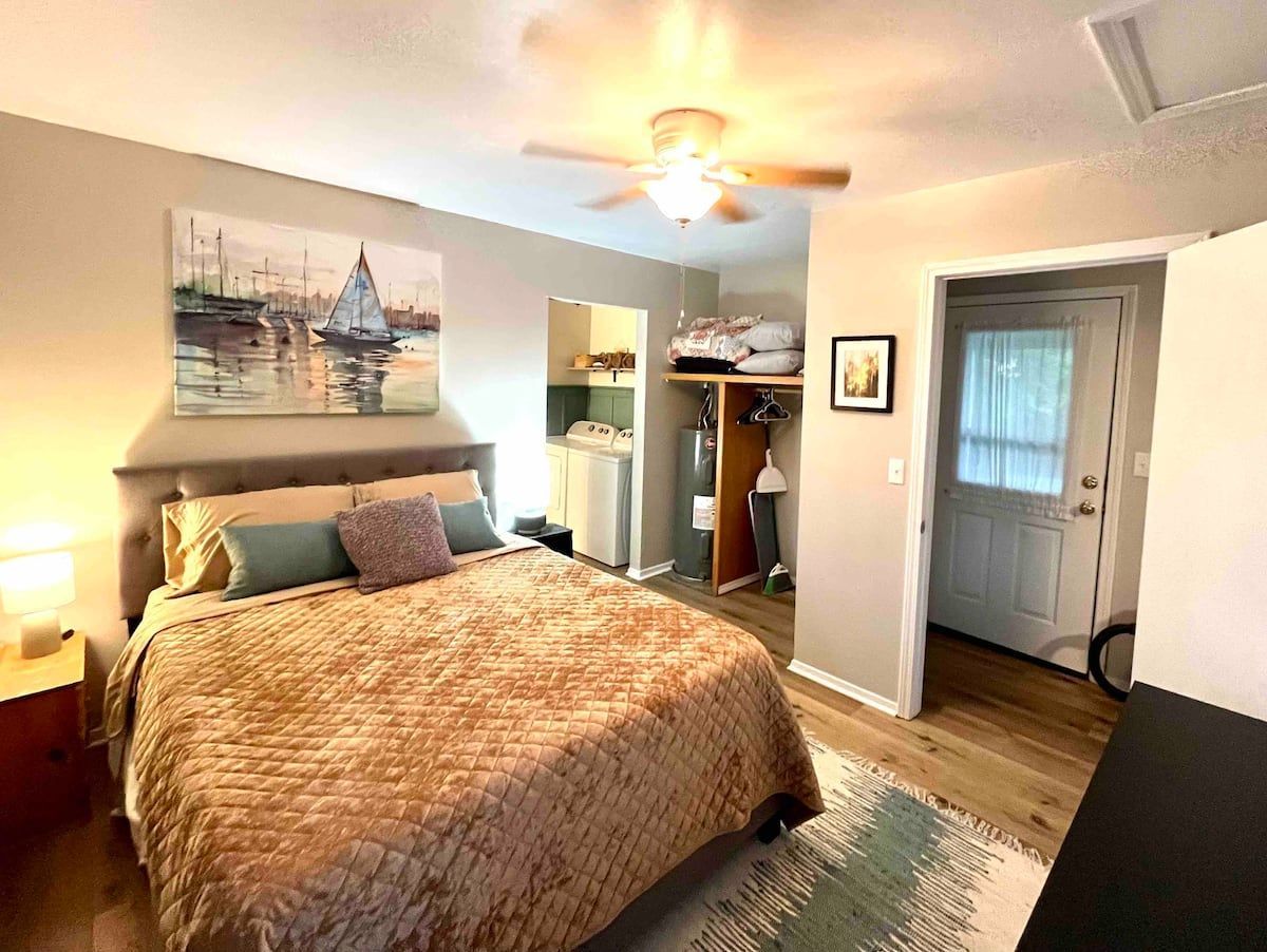 A bedroom with a bed and a ceiling fan.