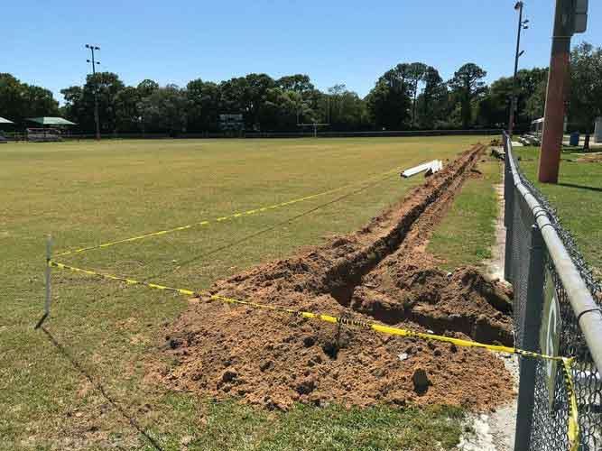 There Is A Hole In The Ground In The Middle Of A Field — Gulf Breeze, FL — Hydraflow Irrigation
