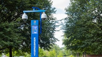 A blue pole with a sign that says welcome on it