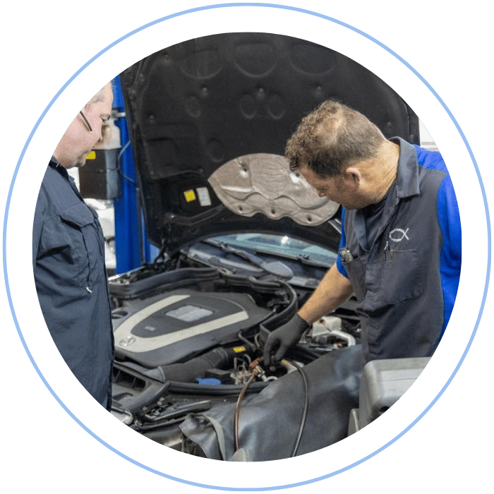 Auto technician inspecting engine diagnostics at Tommy Mathewes Auto Repair