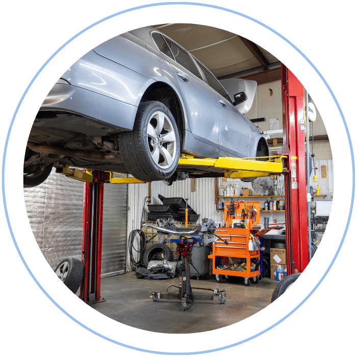 Vehicle raised on lift for alignment service at Tommy Mathewes Auto Repair