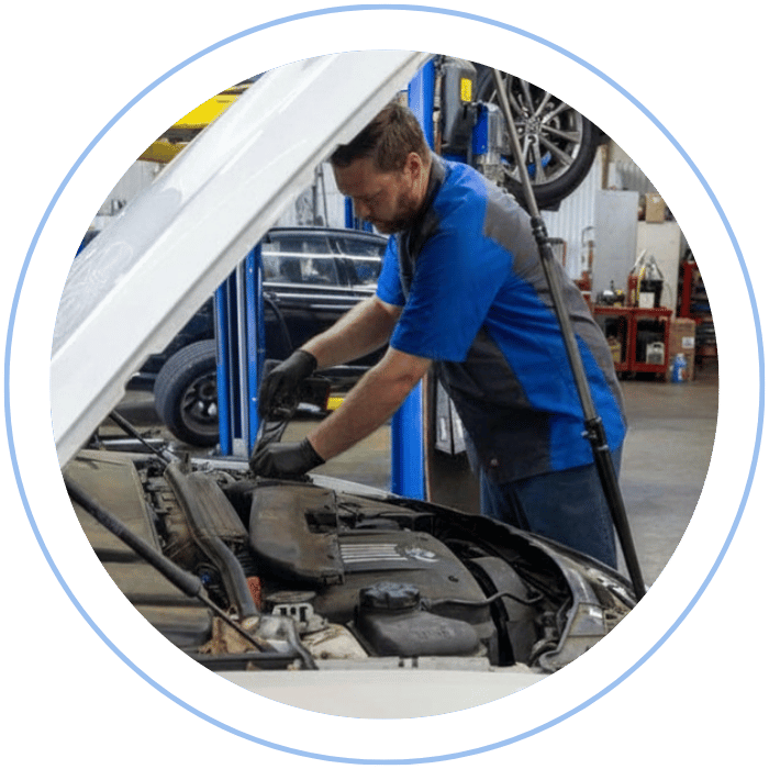 Mechanic working on alternator repair under the hood