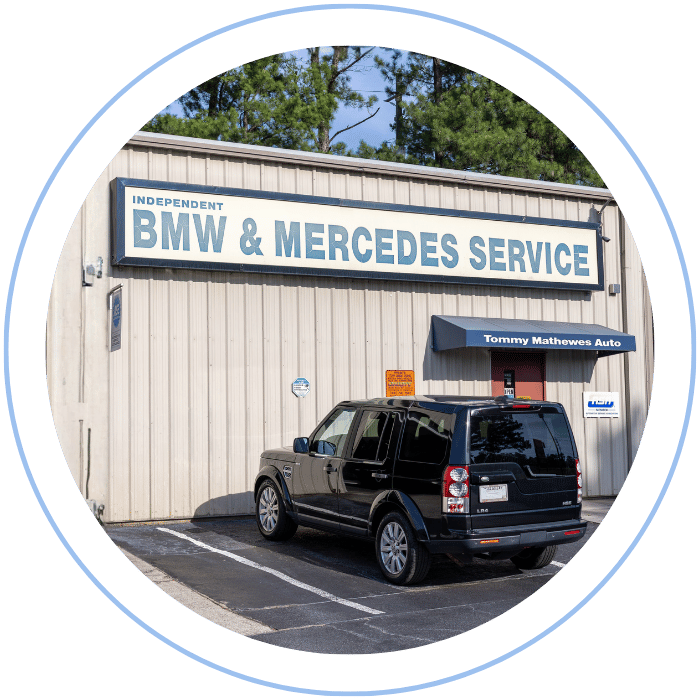 A black SUV parked in front of a building with a sign that reads, 